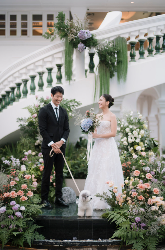 Bride and groom with their dog beside the floral staircase at 1-Flowerhill