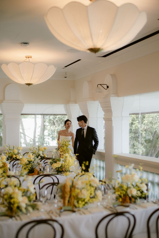 Couple in the light-filled 1-Flowerhill wedding reception space