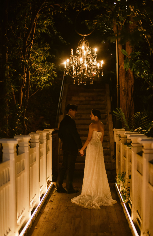 Evening wedding portrait under a chandelier in the 1-Flowerhill gardens